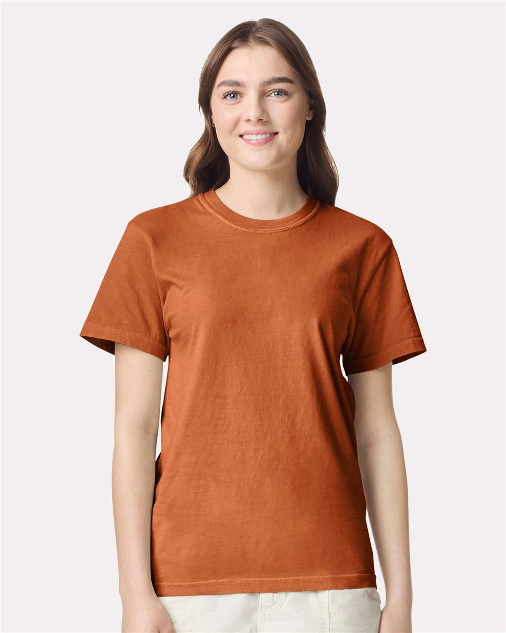 Woman wearing a Yam colored Comfort Colors 1717 heavyweight garment-dyed t-shirt custom DTF printing ready. t-shirt against a white background.